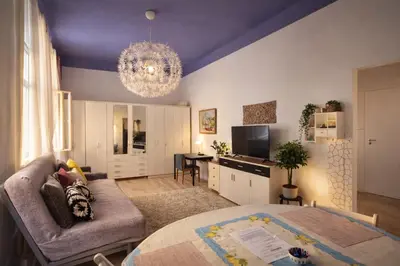 a living room with a couch and a table at Modern Studio in the Heart of Prague 1 , Steps from Main Station and Old Town in Prague