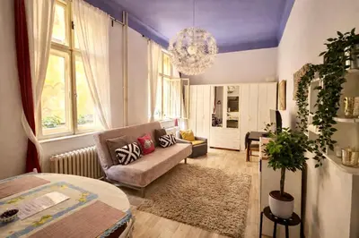 a living room with a couch and a table at Modern Studio in the Heart of Prague 1 , Steps from Main Station and Old Town in Prague