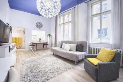 a living room with a couch and a chair at Modern Studio in the Heart of Prague 1 , Steps from Main Station and Old Town in Prague