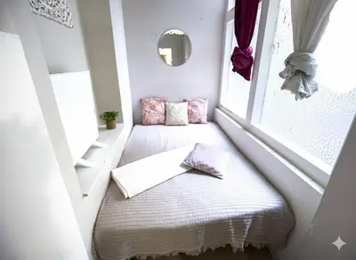 a room with a window with a bed in it at Modern Studio in the Heart of Prague 1 , Steps from Main Station and Old Town in Prague