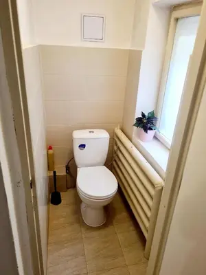 a small bathroom with a toilet and a window at Modern Studio in the Heart of Prague 1 , Steps from Main Station and Old Town in Prague