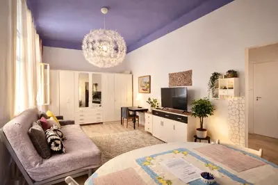a living room with a couch and a table at Modern Studio in the Heart of Prague 1 , Steps from Main Station and Old Town in Prague