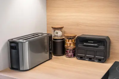 a microwave and a toaster sitting on a counter at Skyline 57m Family Suite with Terrace - Prague Center in Prague