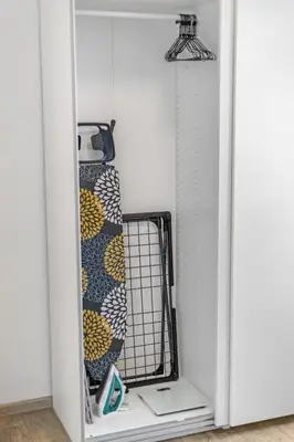 a white door with a shelf with towels in it at Skyline 57m Family Suite with Terrace - Prague Center in Prague