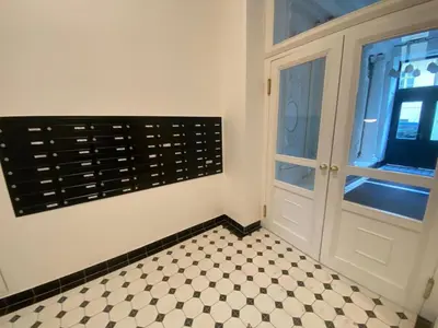 a room with a door and a checkered floor at Prague 1 Apartment Nekázanka in Prague