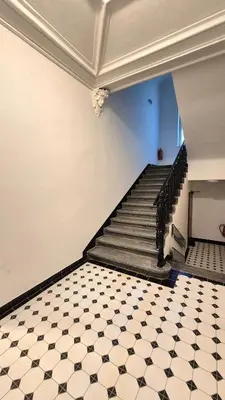 a staircase with a black and white tiled floor at Prague 1 Apartment Nekázanka in Prague