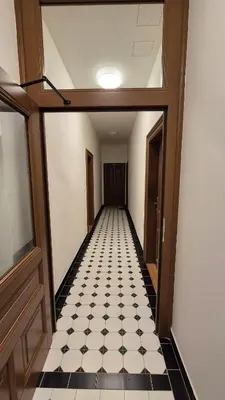 an empty hallway with a black and white checkered floor at Prague 1 Apartment Nekázanka in Prague