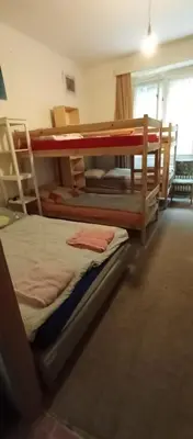 a bedroom with two bunk beds and a window at Bed in shared dormitory near the city centre in Prague