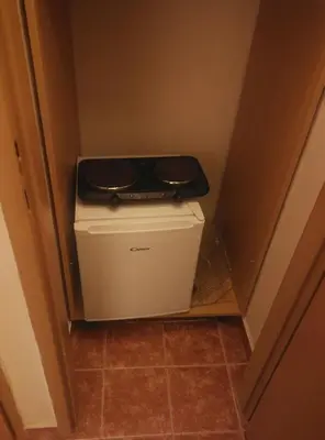 a small refrigerator in a corner of a room at Bed in shared dormitory near the city centre in Prague