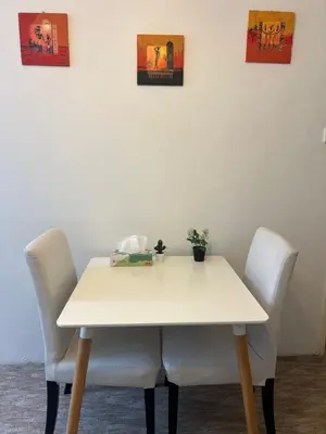 a small kitchen with white walls and wooden cabinets at Peaceful apartment - centre in 10 min in Prague