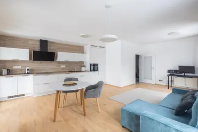 a living room with a blue couch and a table at Prague apartment with balcony in Prague
