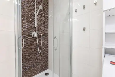 a bathroom with a shower with a glass at Newly renovated apartment next to the National Museum in Prague