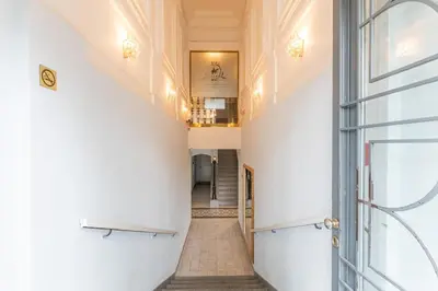 a hallway in a building with a door and a staircase at Newly renovated apartment next to the National Museum in Prague