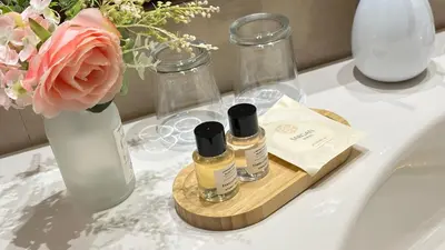 a bathroom counter with two bottles of essential oils and a flower at Fleur De Lis Hotel in Prague