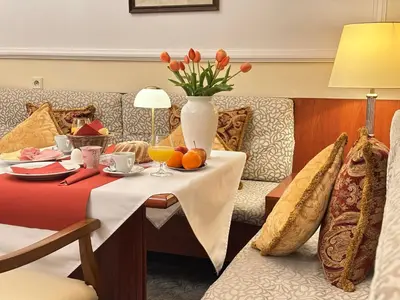 a hotel room with a table with a vase of flowers at Fleur De Lis Hotel in Prague