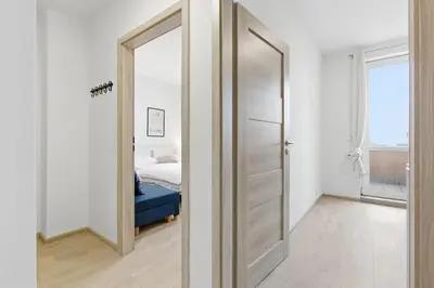 a bedroom with a door leading to a bed at Apartment near the subway with kitchen and terrace in Prague