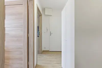 a hallway with a door leading into a room at Apartment near the subway with kitchen and terrace in Prague