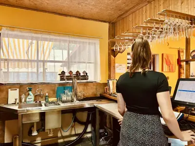 a woman standing in a kitchen with a sink at Camp Litomerice in Litoměřice