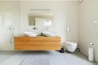 a bathroom with two sinks and a toilet at Prague Airport Luxury Vila in Prague