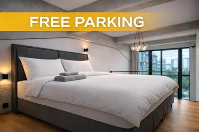 a bedroom with a large bed with white sheets and pillows at Prague Design Loft Kolbenova, Metro, Parking in Prague