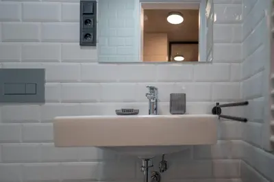 a bathroom with a sink and a toilet and a mirror at Prague Design Loft Kolbenova, Metro, Parking in Prague