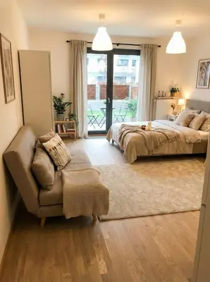 a bedroom with a bed and a couch and a window at Fortuna Garden I in Prague