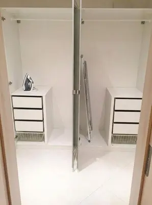 a room with white cabinets and a glass door at Fortuna Garden I in Prague