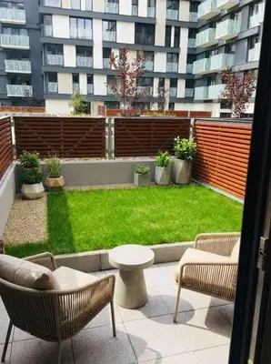 a patio with chairs and a lawn in front of a building at Fortuna Garden I in Prague