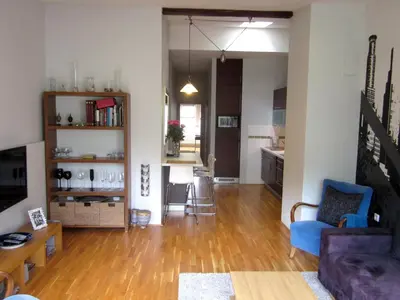 a living room with a couch and a table at Prague City Loft And Studio in Prague