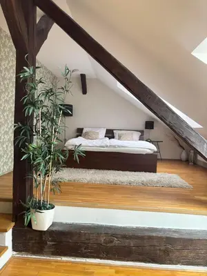a bedroom with a bed with plants in it at Prague City Loft And Studio in Prague