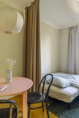 a room with a table and chairs and a bed at Bohemian Mystery by Prague Castle in Prague