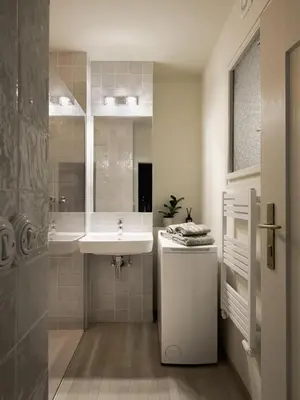 a white bathroom with a sink and a shower at Bohemian Mystery by Prague Castle in Prague