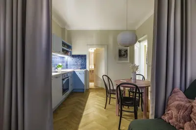 a kitchen and dining room with a table and chairs at Bohemian Mystery by Prague Castle in Prague