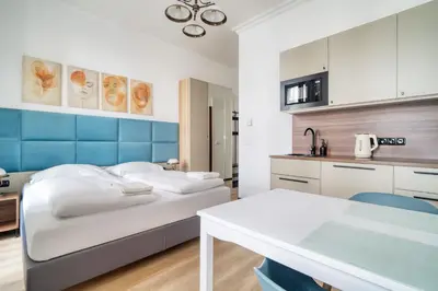 a hospital room with a bed and a table at Royal Vineyards Apartment in Prague
