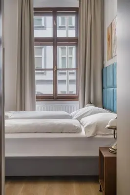 a bed in a room with a window at Royal Vineyards Apartment in Prague