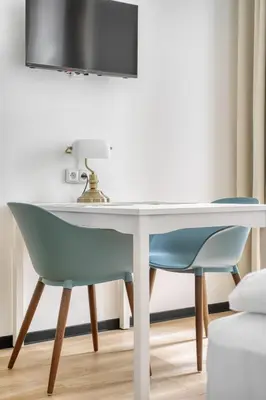 a table and two chairs in a room at Royal Vineyards Apartment in Prague