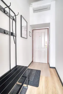 a hallway with a white door and a black rug at Royal Vineyards Apartment in Prague