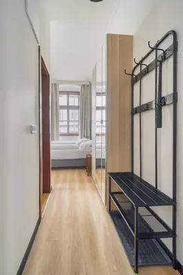 a room with a walk in closet with a black shelf at Royal Vineyards Apartment in Prague