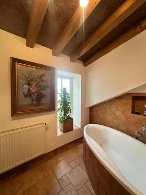 a large bathroom with a tub and a window at Apartmán Míšeňská in Prague