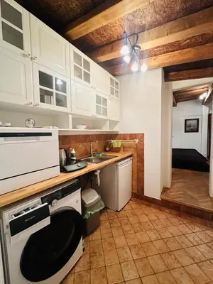 a kitchen with white cabinets and a stove at Apartmán Míšeňská in Prague