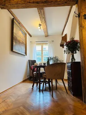 a dining room with a table and chairs at Apartmán Míšeňská in Prague