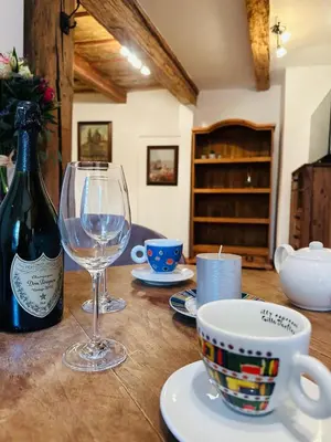 a table with a bottle of wine and a glass at Apartmán Míšeňská in Prague