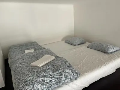 a bedroom with two twin beds with pillows at Central cozy rooms Soukenická S31 in Prague