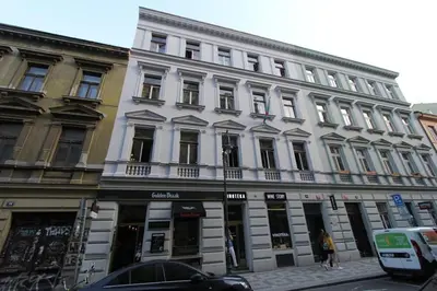 a large white building on a city street at Central cozy rooms Soukenická S31 in Prague