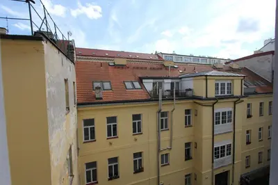 a yellow building with a group of buildings at Central cozy rooms Soukenická S31 in Prague