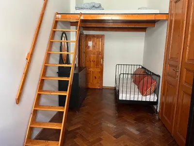 a room with a bunk bed and a ladder at Central cozy rooms Soukenická S31 in Prague