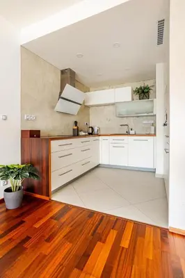 a kitchen with white cabinets and a sink at Luxury Apartment in the Heart of Prague in Prague
