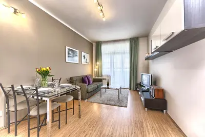 a living room with a dining table and a couch at Ostrovni 7 Apartments in Prague