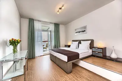 a bedroom with a bed and a glass table at Ostrovni 7 Apartments in Prague