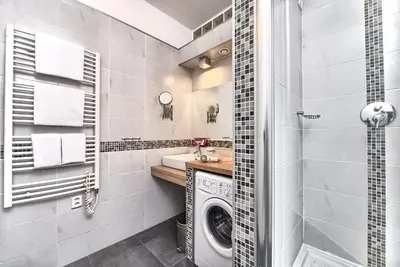 a bathroom with a washing machine and a sink at Ostrovni 7 Apartments in Prague
